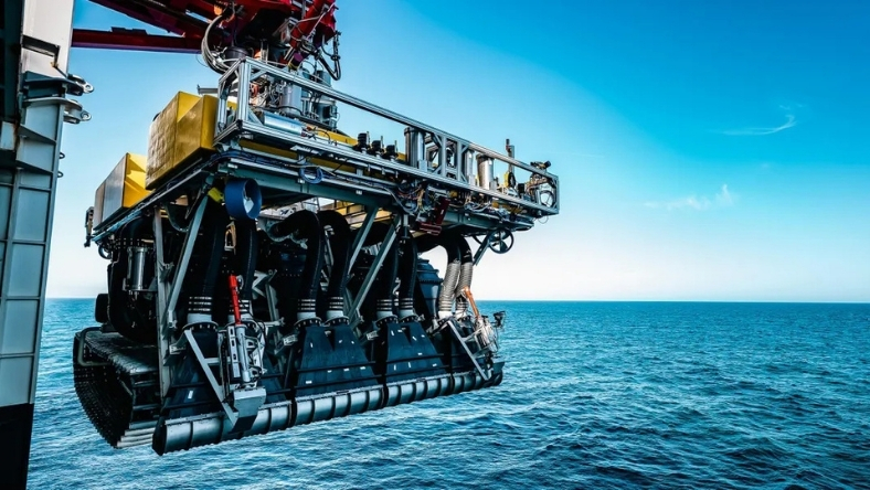 Underwater mining robot suspended above ocean during deployment